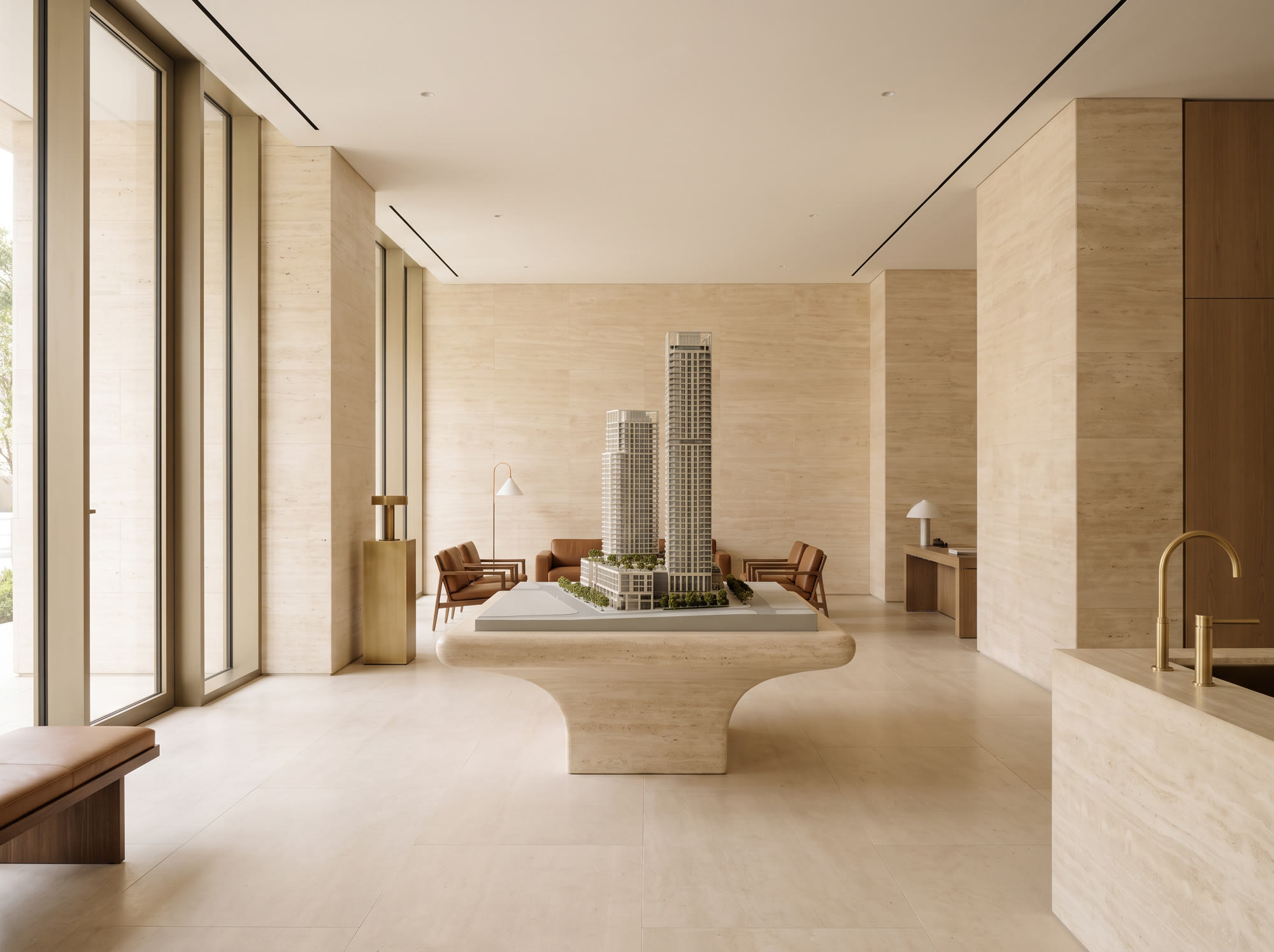 An empty luxury sales gallery with an architectural model on a stone plinth
